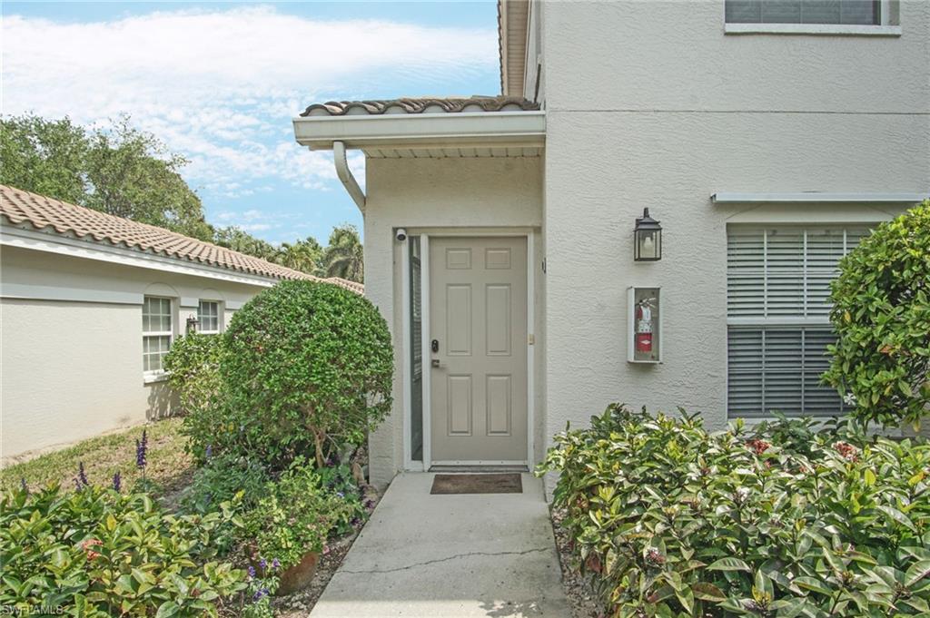 6910 Satinleaf Road North, Unit 204 Naples, FL 34109 - Photo 4 of 31 Property entrance with stucco siding and a tile roof