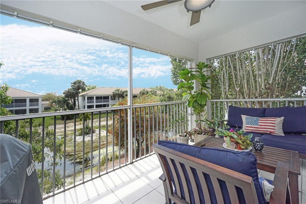 6910 Satinleaf Road North, Unit 204 Naples, FL 34109 - Photo 9 of 31 Sunroom featuring outdoor lounge area and ceiling fan