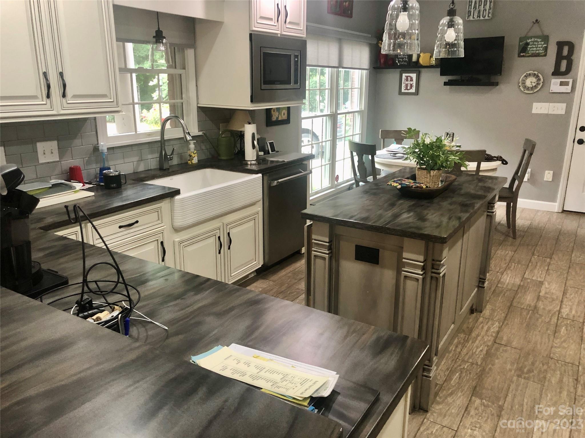 213 Forest Ridge Drive Rutherfordton, NC 28139 - Photo 2 of 5 a kitchen with kitchen island granite countertop a dining table chairs sink and cabinets