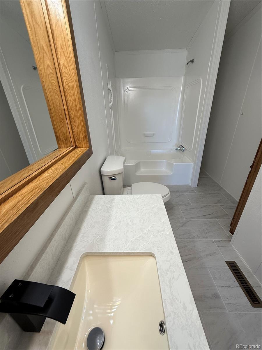 623 Prairie Avenue Brighton, CO 80603 - Photo 15 of 35 a bathroom with a tub and a shower