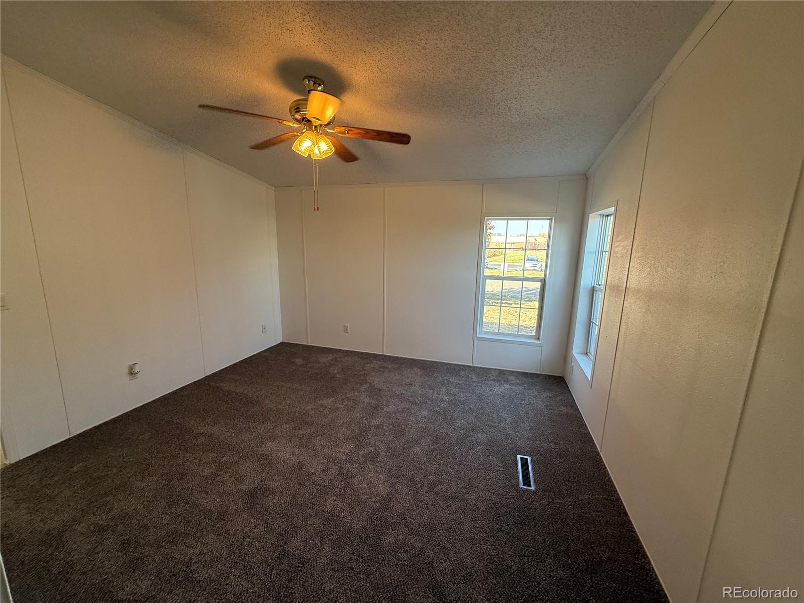623 Prairie Avenue Brighton, CO 80603 - Photo 18 of 35 wooden floor in an empty room with a window