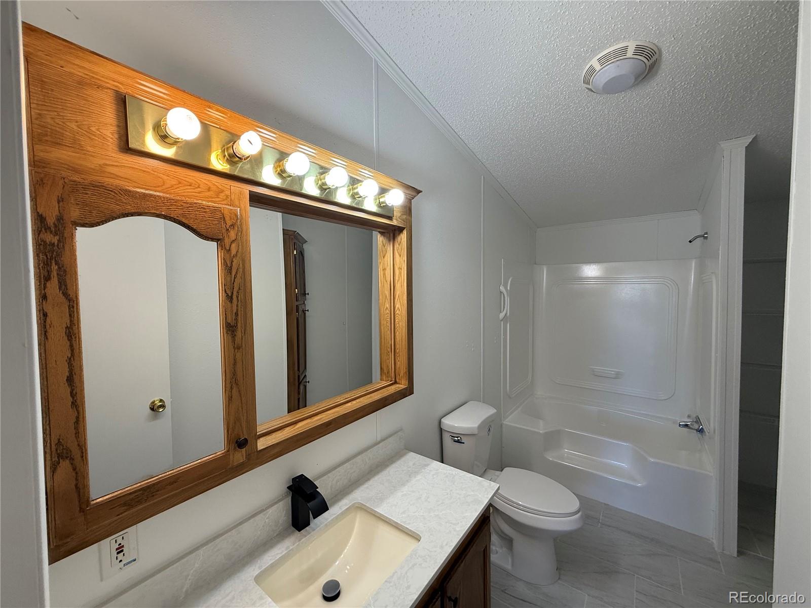 623 Prairie Avenue Brighton, CO 80603 - Photo 19 of 35 a bathroom with a sink a toilet and shower