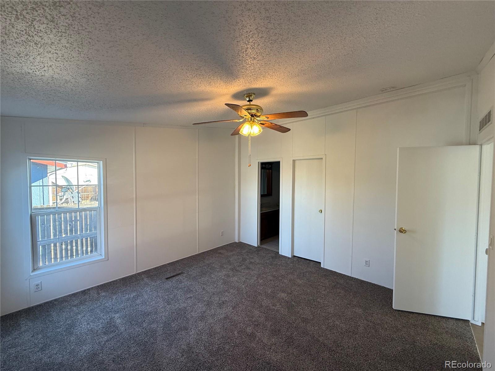 623 Prairie Avenue Brighton, CO 80603 - Photo 20 of 35 a view of an empty room with a ceiling fan