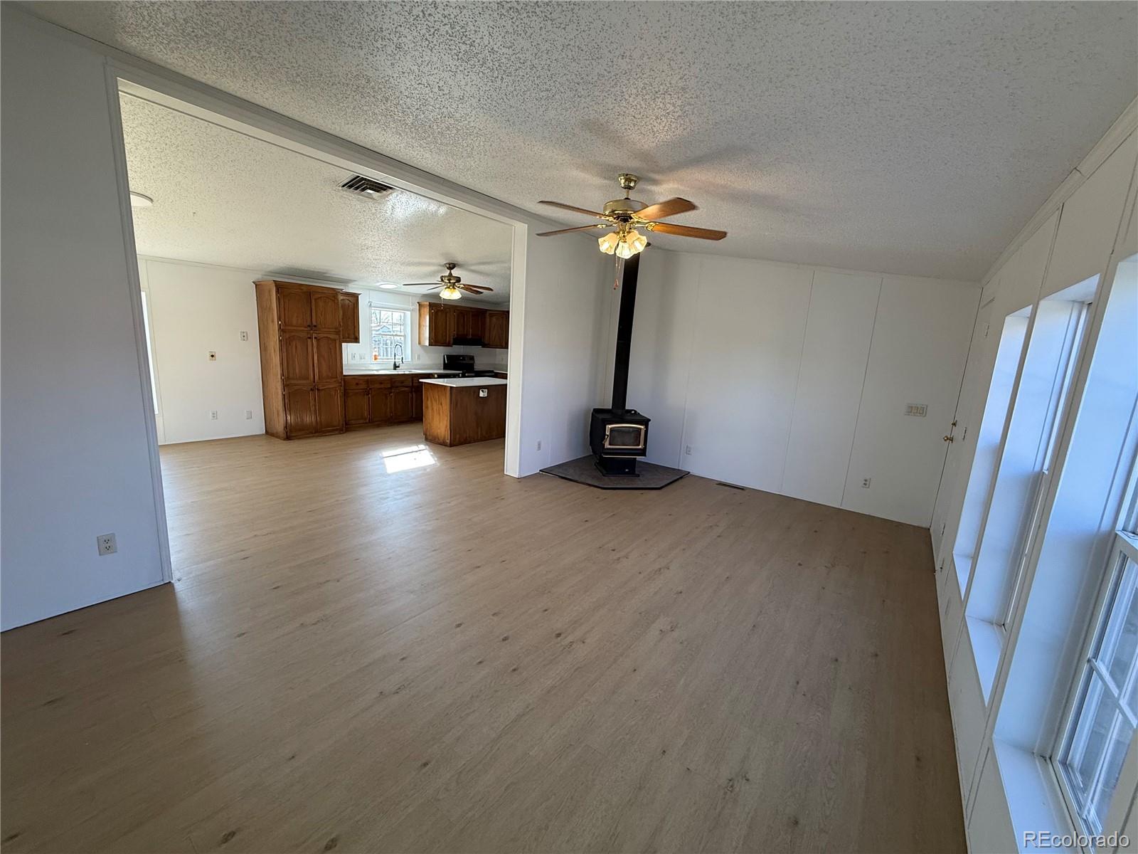 623 Prairie Avenue Brighton, CO 80603 - Photo 22 of 35 wooden floor in an empty room with a window
