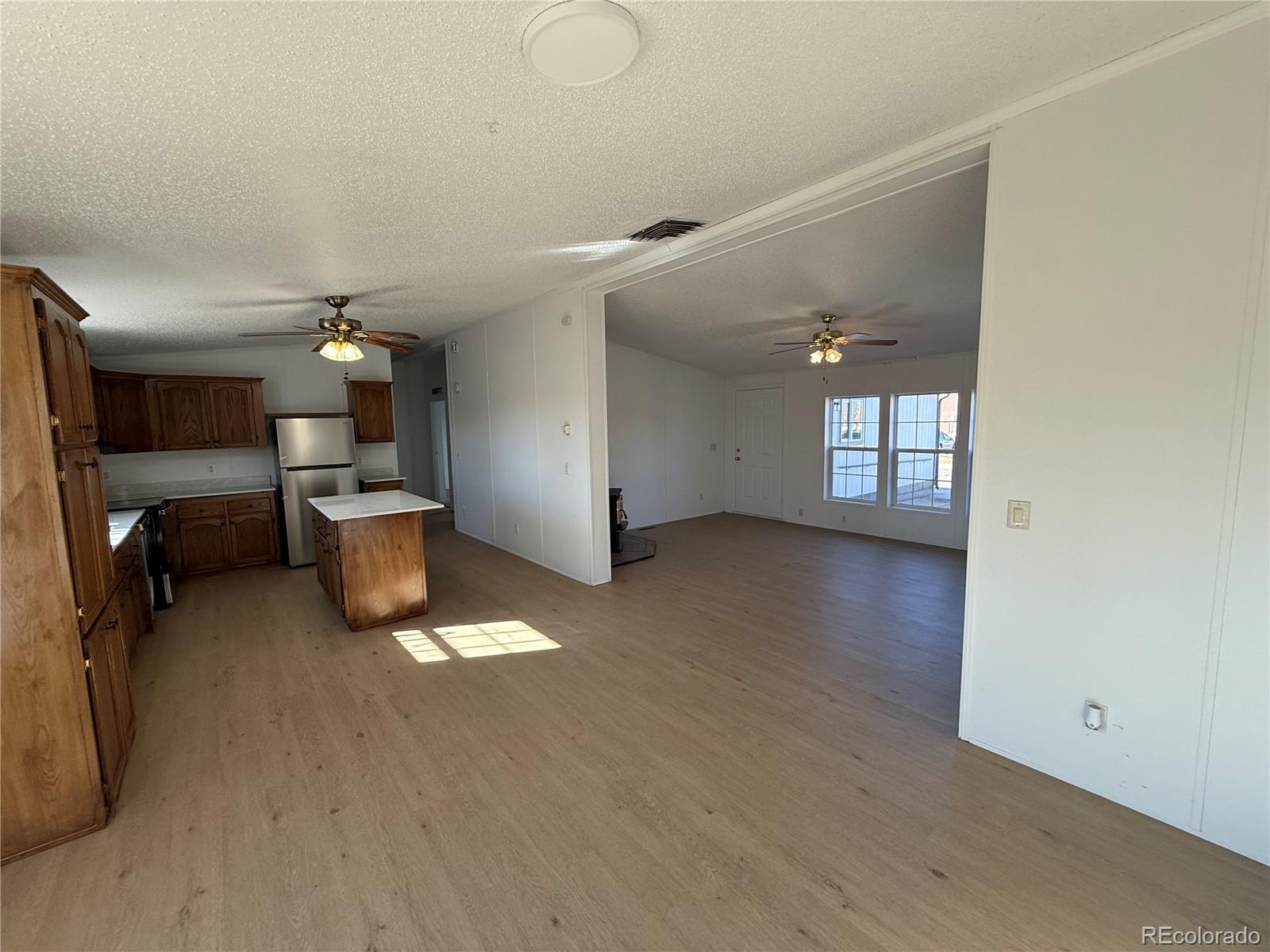 623 Prairie Avenue Brighton, CO 80603 - Photo 23 of 35 a view of a livingroom with furniture and a kitchen