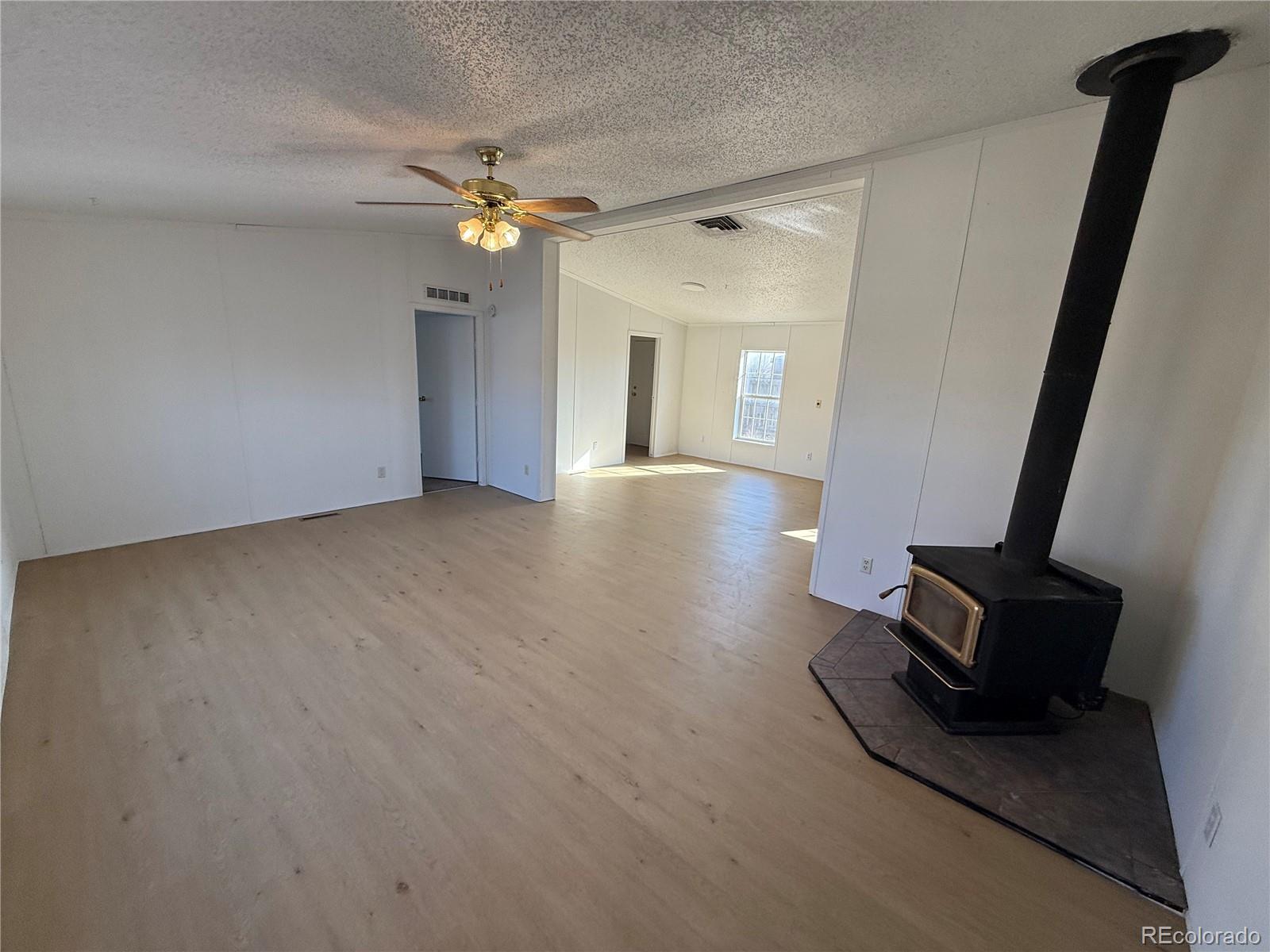 623 Prairie Avenue Brighton, CO 80603 - Photo 3 of 35 wooden floor in an empty room with a window