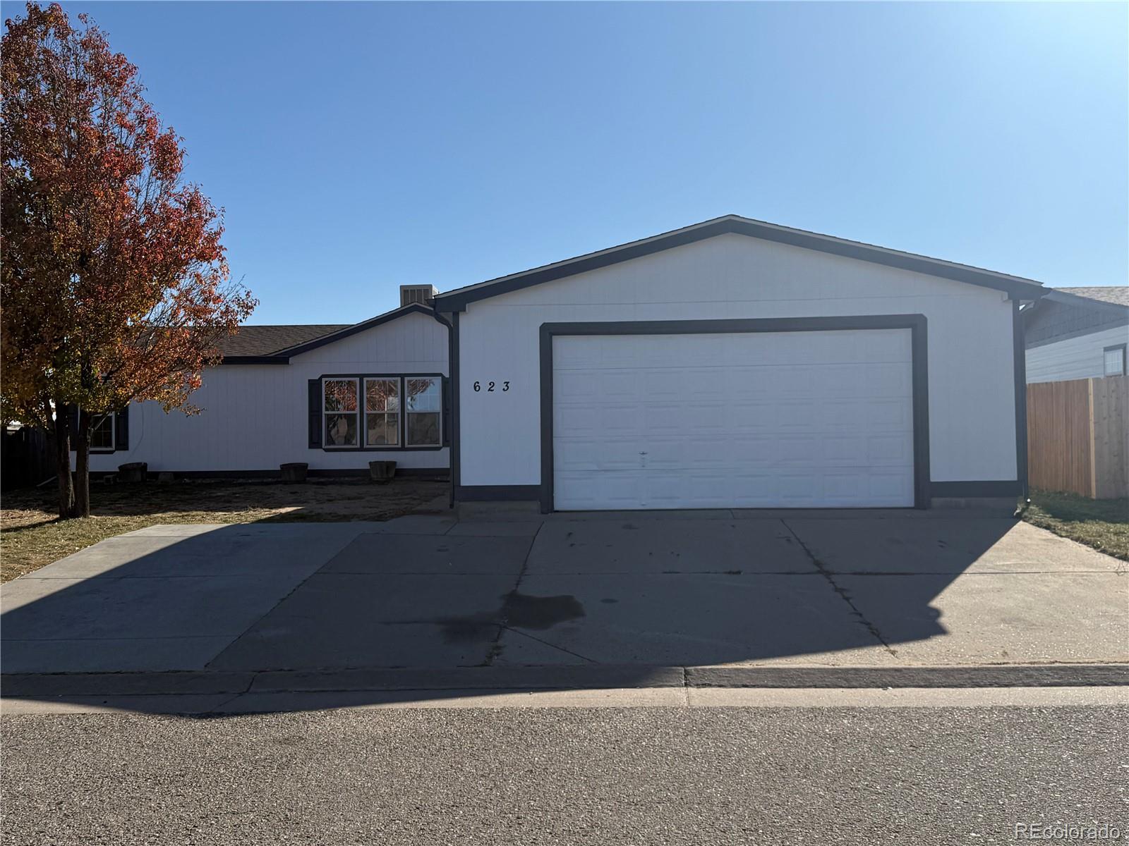 623 Prairie Avenue Brighton, CO 80603 - Photo 34 of 35 a front view of a house with a yard and garage