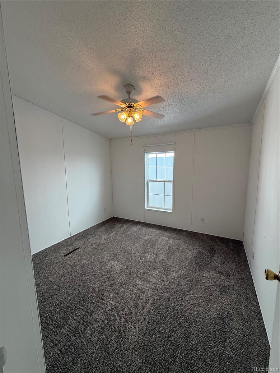 623 Prairie Avenue Brighton, CO 80603 - Photo 8 of 35 an empty room with windows and fan
