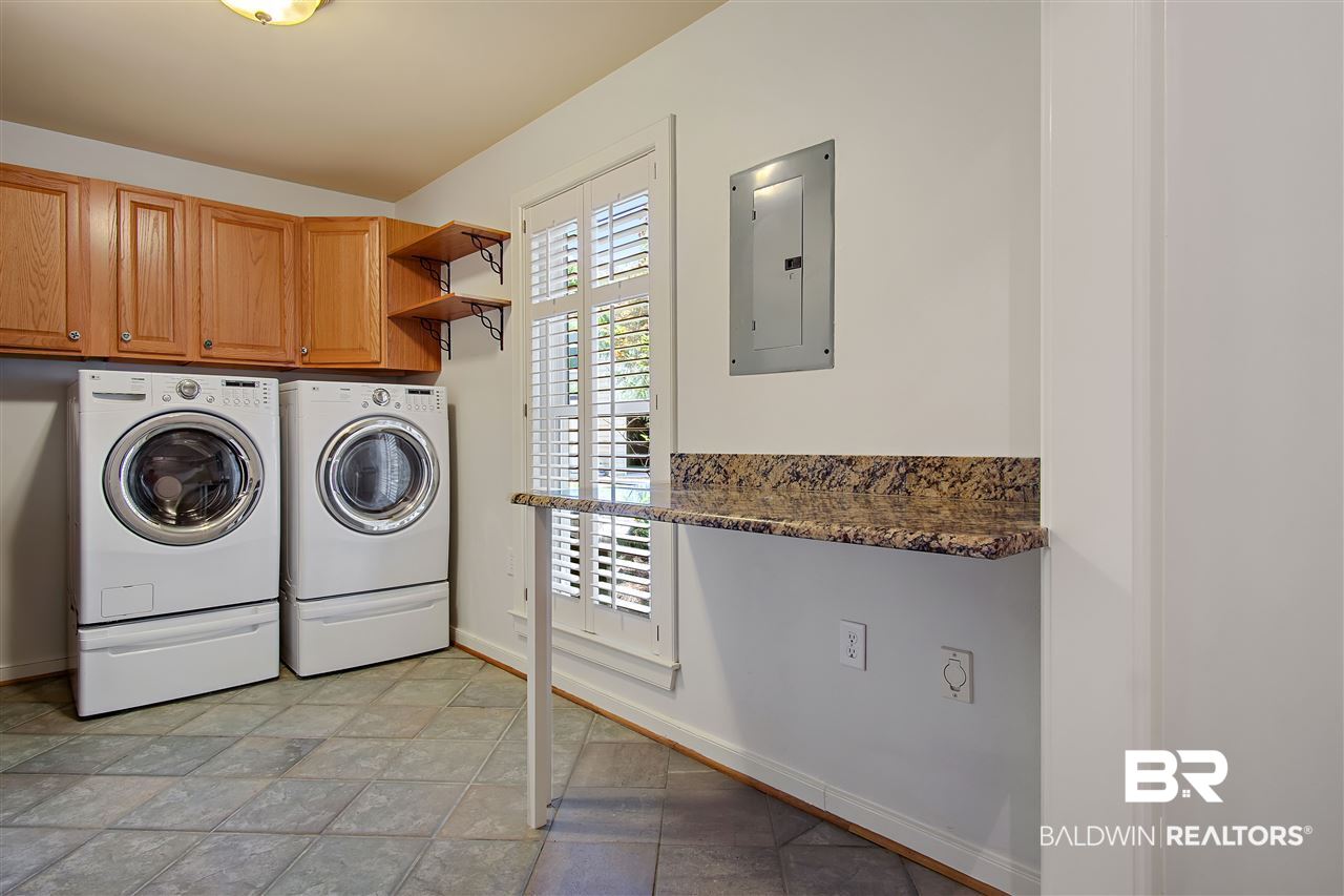 3136 Cumberland Road Theodore, AL 36582 - Photo 41 of 50 Large utility room with cabinets and counter tops.