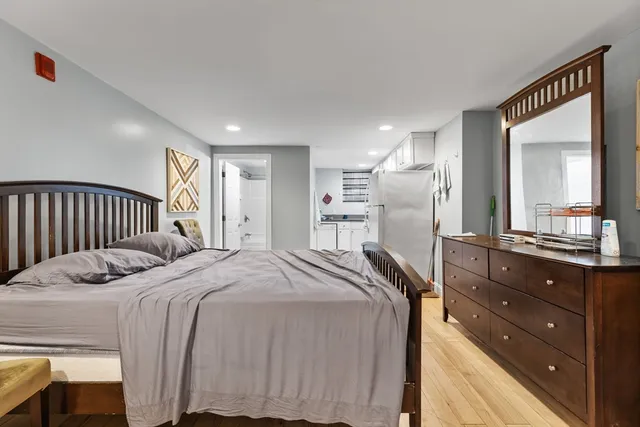 a bed room with a bed and a mirror