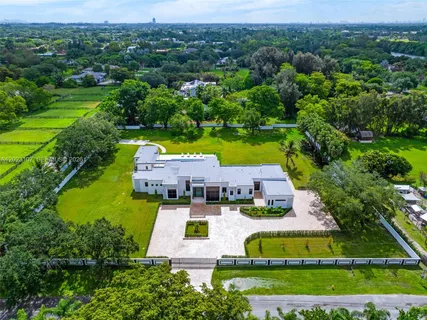 an aerial view of a house with a swimming pool yard and outdoor seating