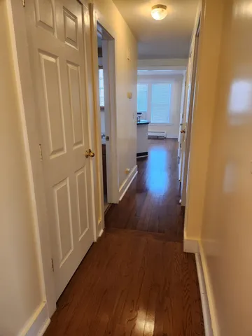 a view of a hallway with wooden floor