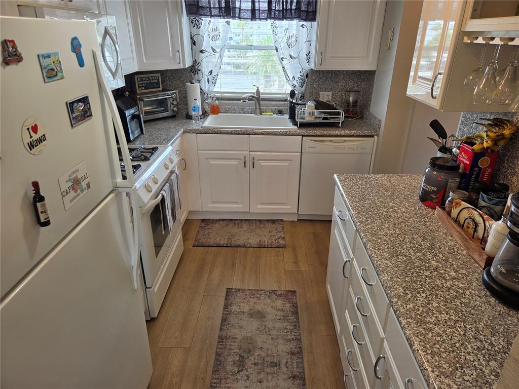 7 Dunoon Place, Unit 309 Dunedin, FL 34698 - Photo 9 of 25 a kitchen with appliances cabinets and a sink