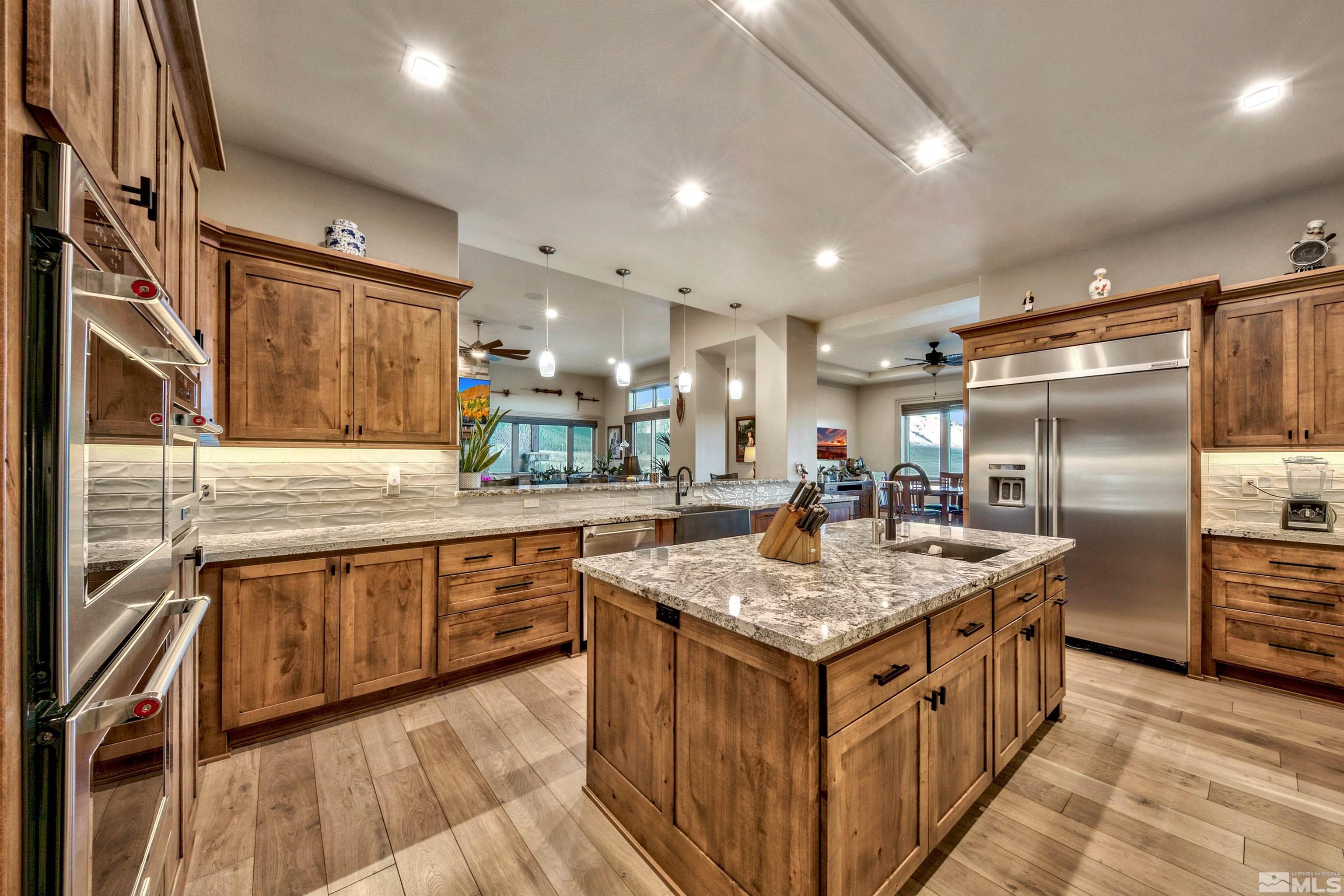 316 James Canyon Loop Genoa, NV 89411 - Photo 12 of 40 a kitchen with granite countertop counter top space a sink stainless steel appliances and cabinets