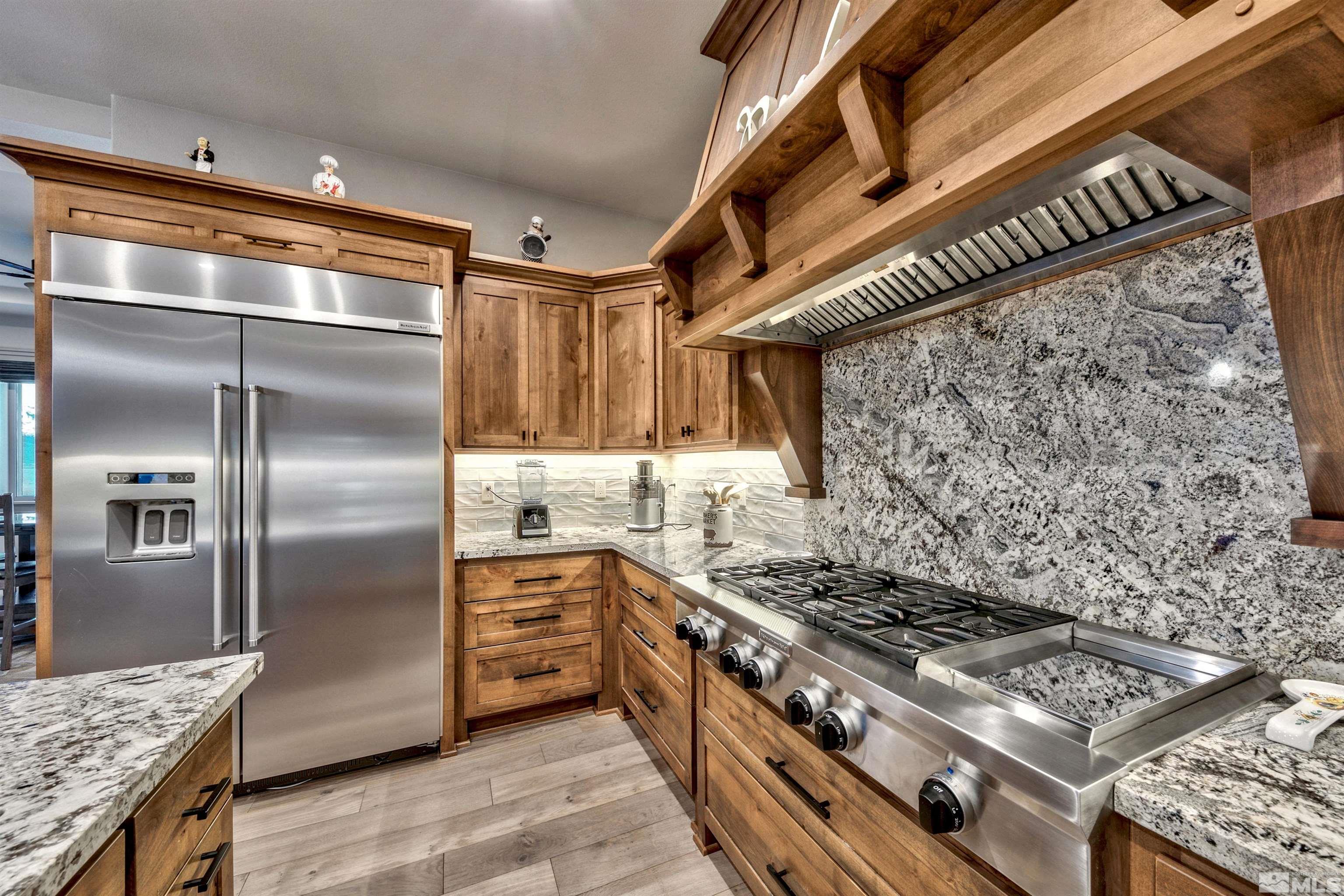 316 James Canyon Loop Genoa, NV 89411 - Photo 13 of 40 a kitchen with stainless steel appliances granite countertop a stove and a refrigerator