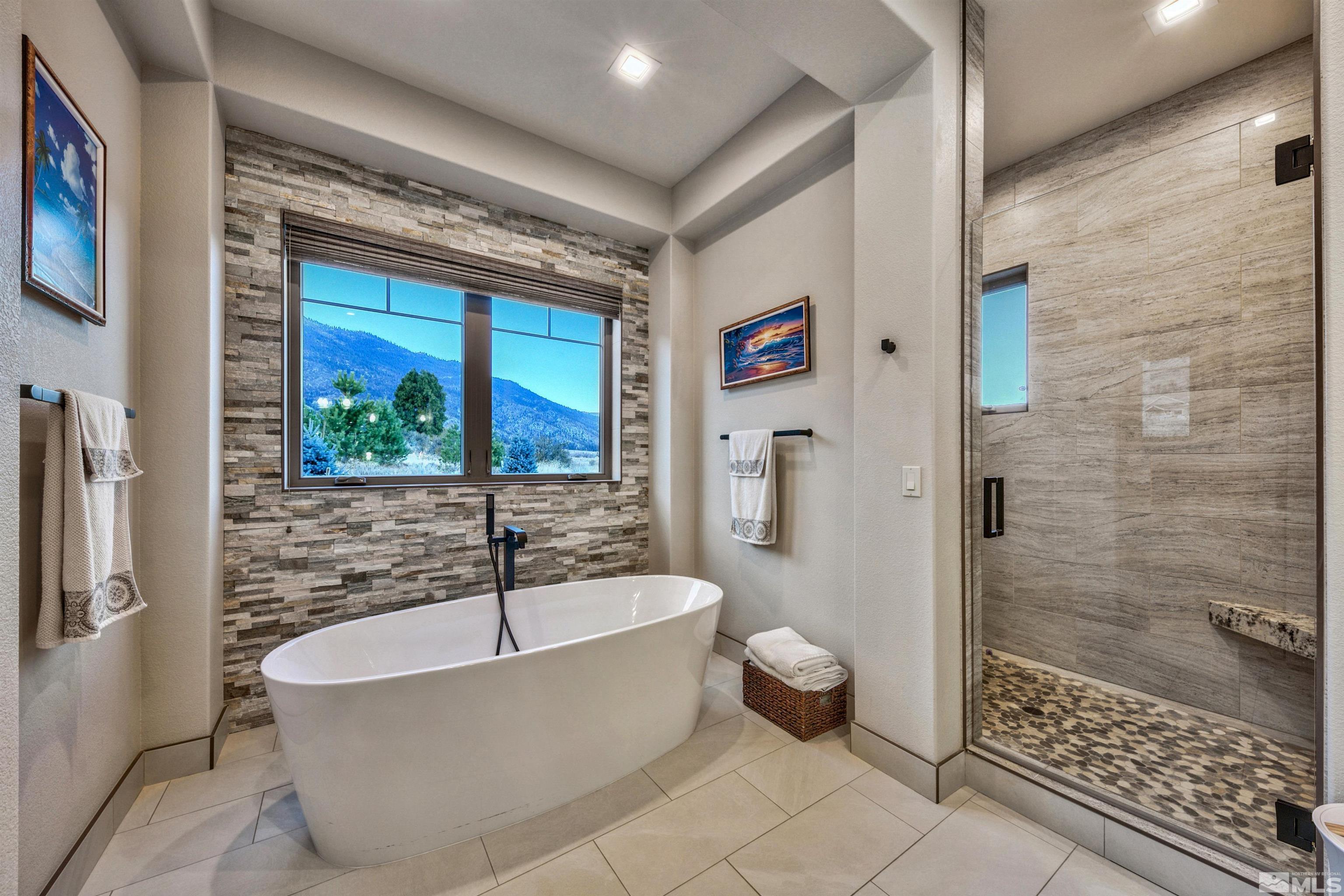 316 James Canyon Loop Genoa, NV 89411 - Photo 17 of 40 a bathroom with a bathtub and a shower