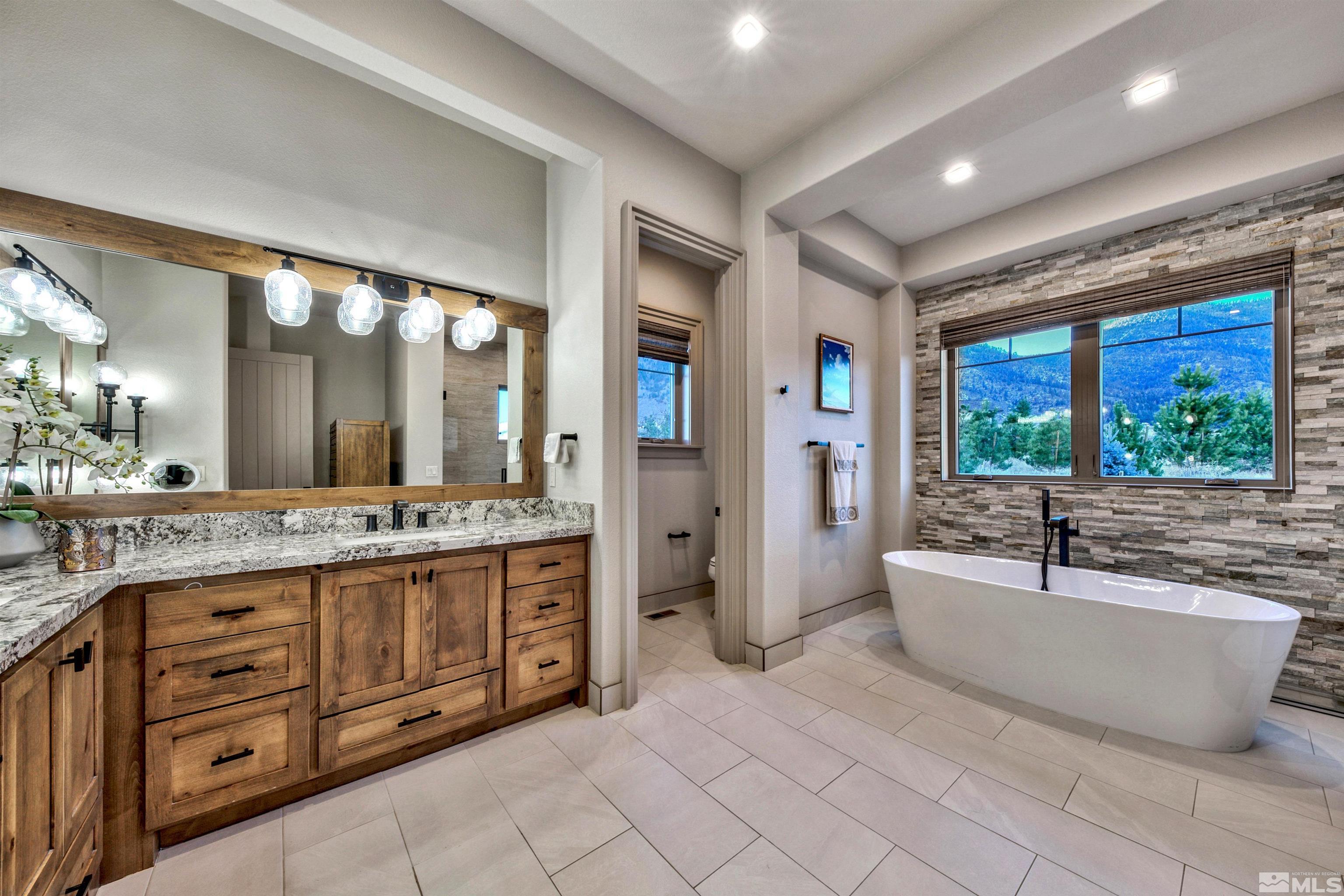 316 James Canyon Loop Genoa, NV 89411 - Photo 18 of 40 a large bathroom with a large tub and sink
