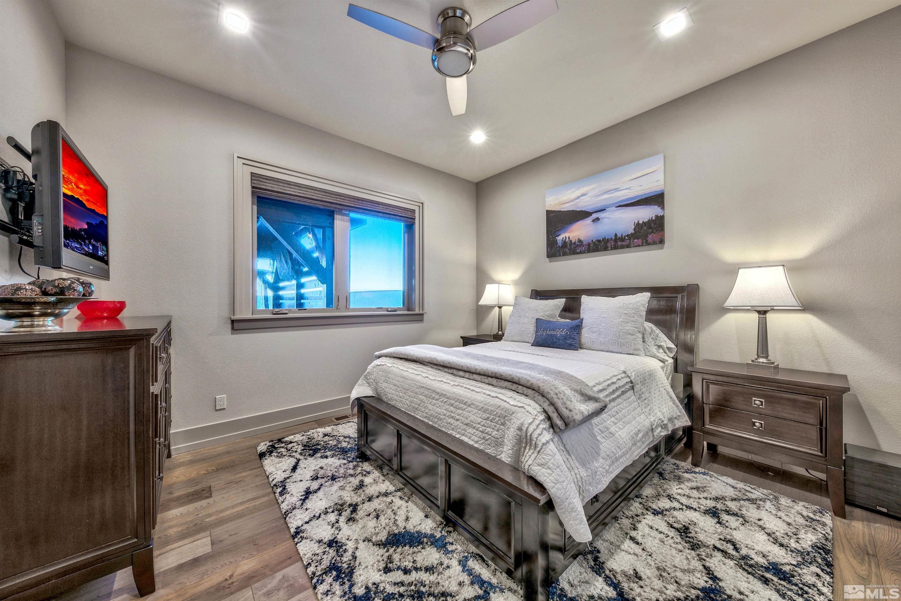 316 James Canyon Loop Genoa, NV 89411 - Photo 19 of 40 a bedroom with a bed and a flat screen tv