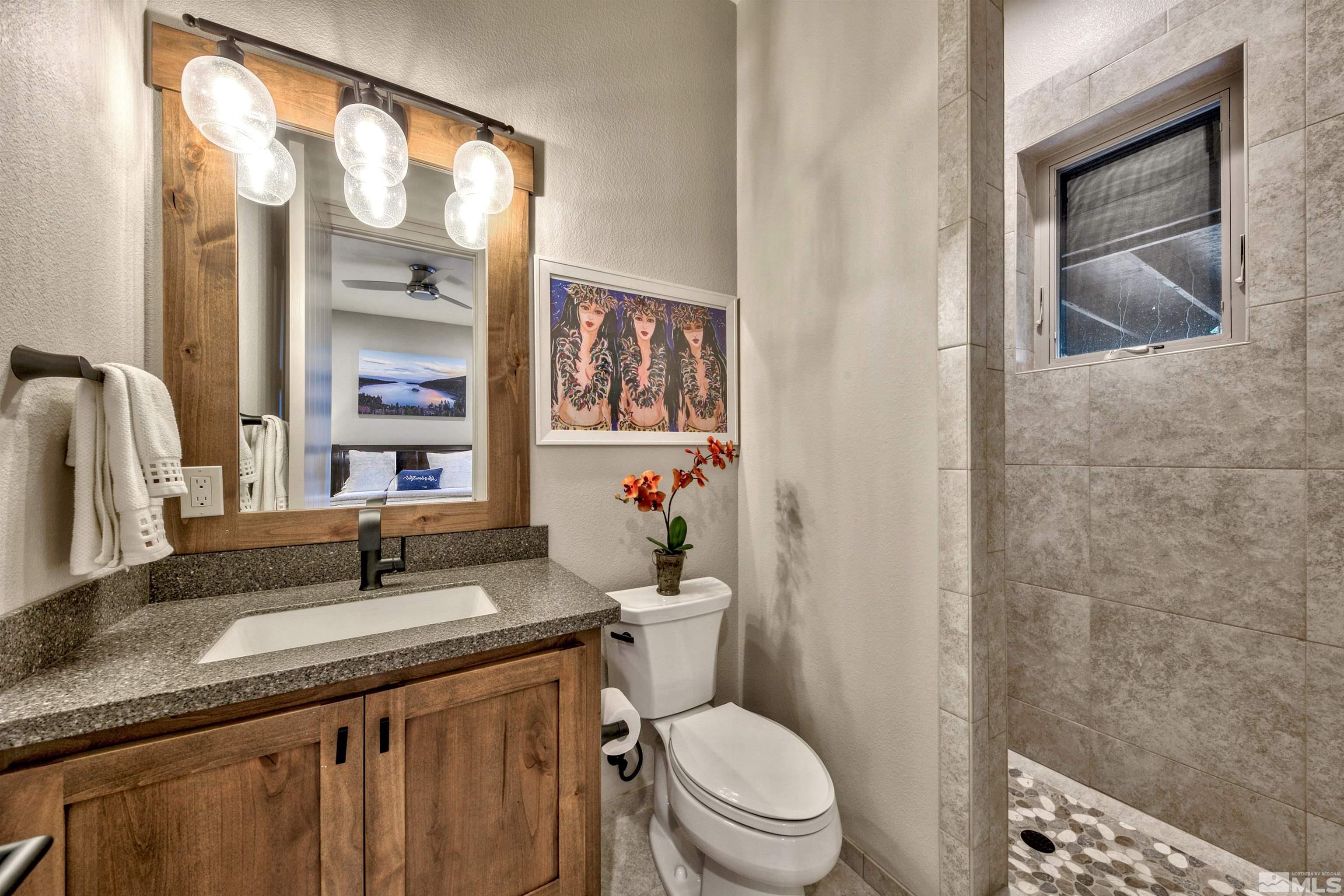 316 James Canyon Loop Genoa, NV 89411 - Photo 20 of 40 a bathroom with a granite countertop sink mirror vanity and toilet