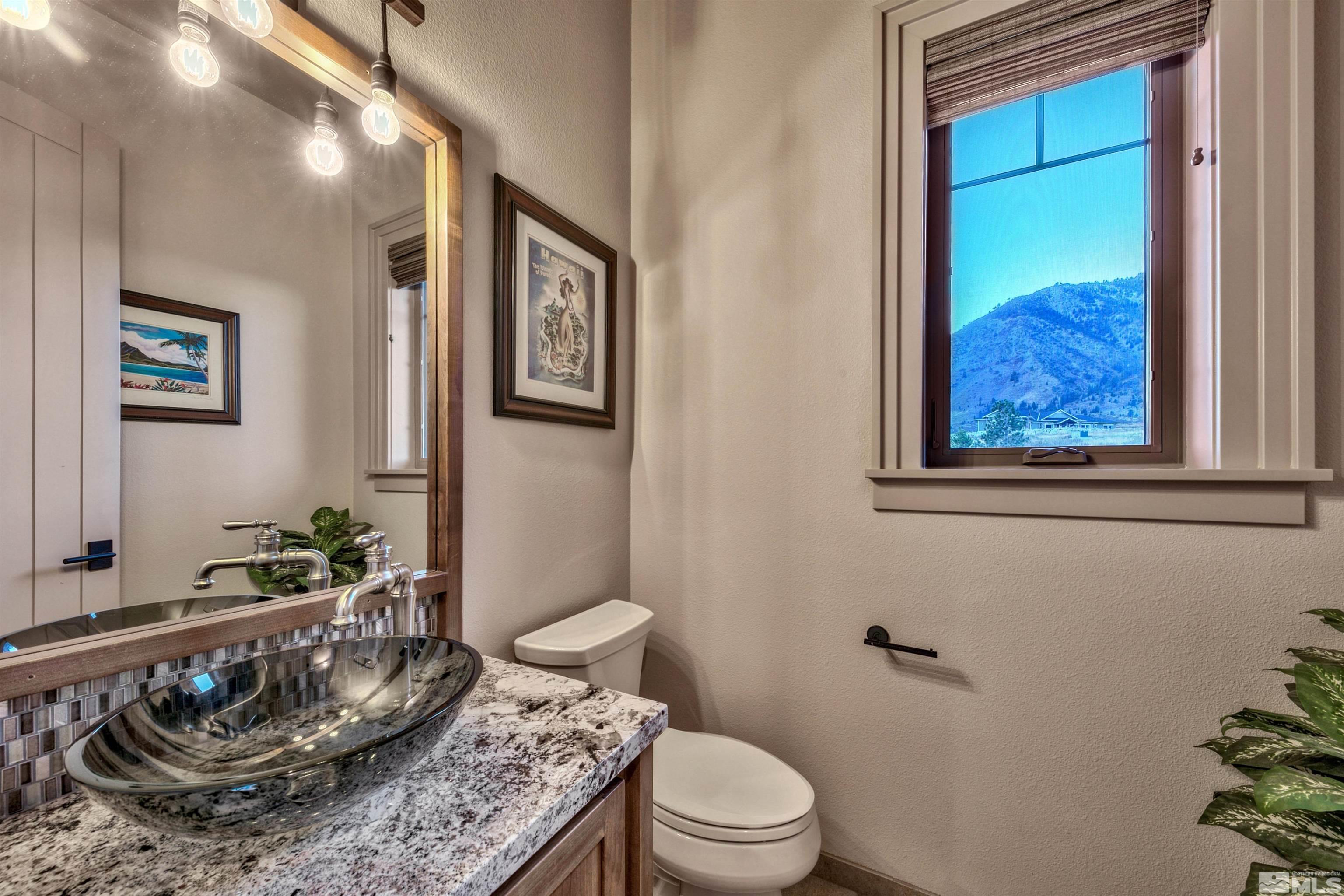316 James Canyon Loop Genoa, NV 89411 - Photo 21 of 40 a bathroom with a granite countertop sink and a mirror