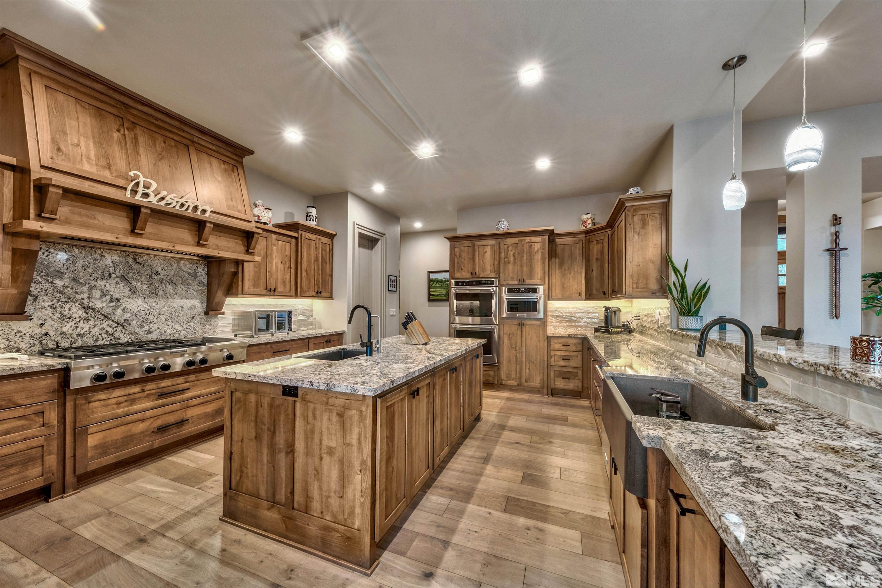 316 James Canyon Loop Genoa, NV 89411 - Photo 10 of 40 a kitchen with counter top space a sink and appliances
