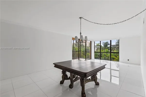 a view of a room with window table and chairs