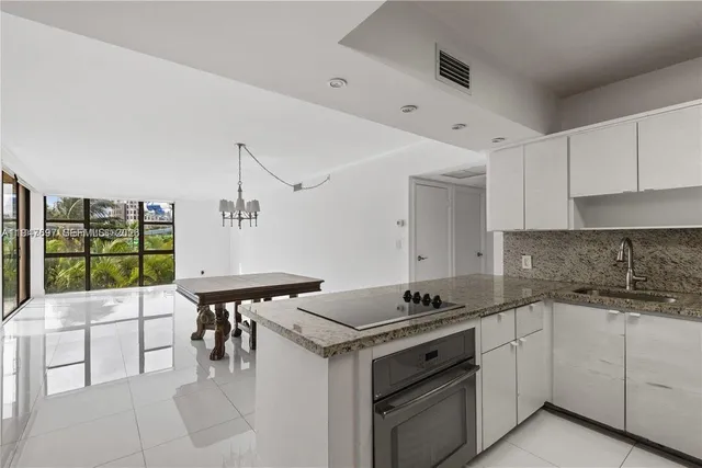 a kitchen that has a sink and a stove in it