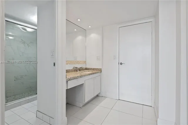 a view of a bathroom with a granite countertop sink mirror and shower