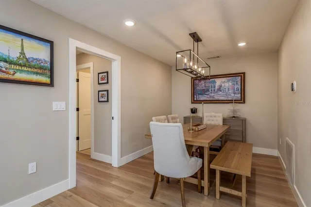 a view of a dining room with furniture wooden floor and a chandelier