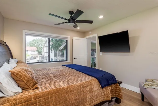 a bedroom with a large bed and a flat screen tv