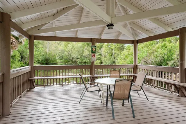 a view of a deck with furniture and wooden floor