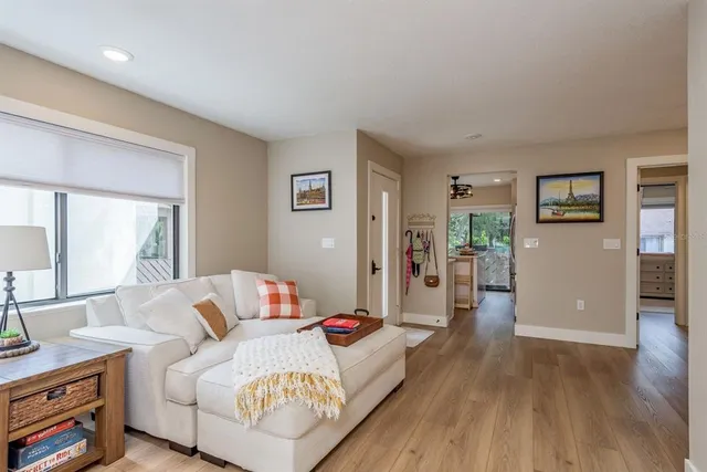a bedroom with furniture and a wooden floor