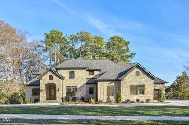 a front view of a house with a yard porch and furniture