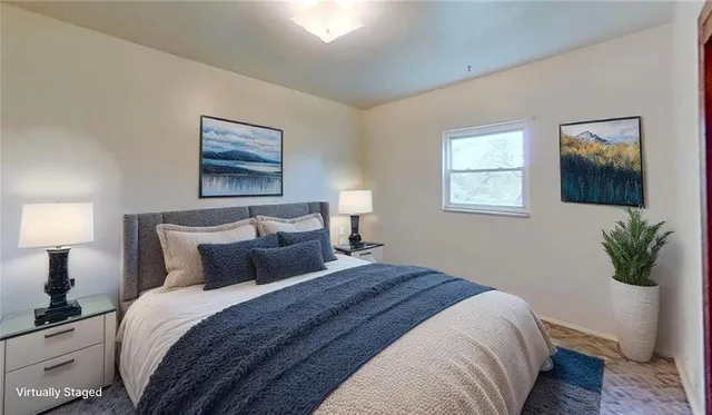 a bedroom with a bed and a painting on the wall