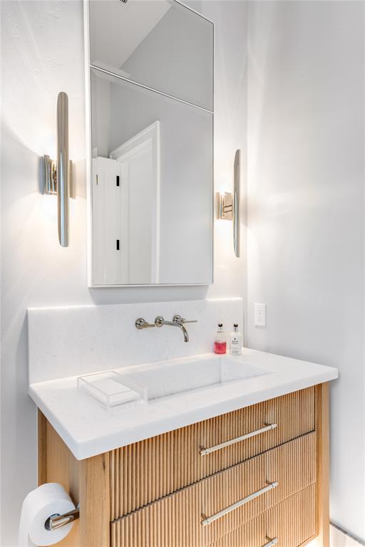 4306 Gloster Road Dallas, TX 75220 - Photo 23 of 28 a bathroom with a sink and a mirror