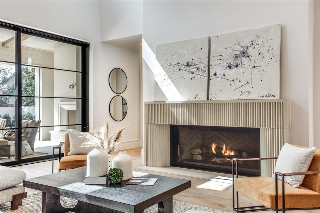 4306 Gloster Road Dallas, TX 75220 - Photo 7 of 28 a living room with furniture a fireplace and wooden floor
