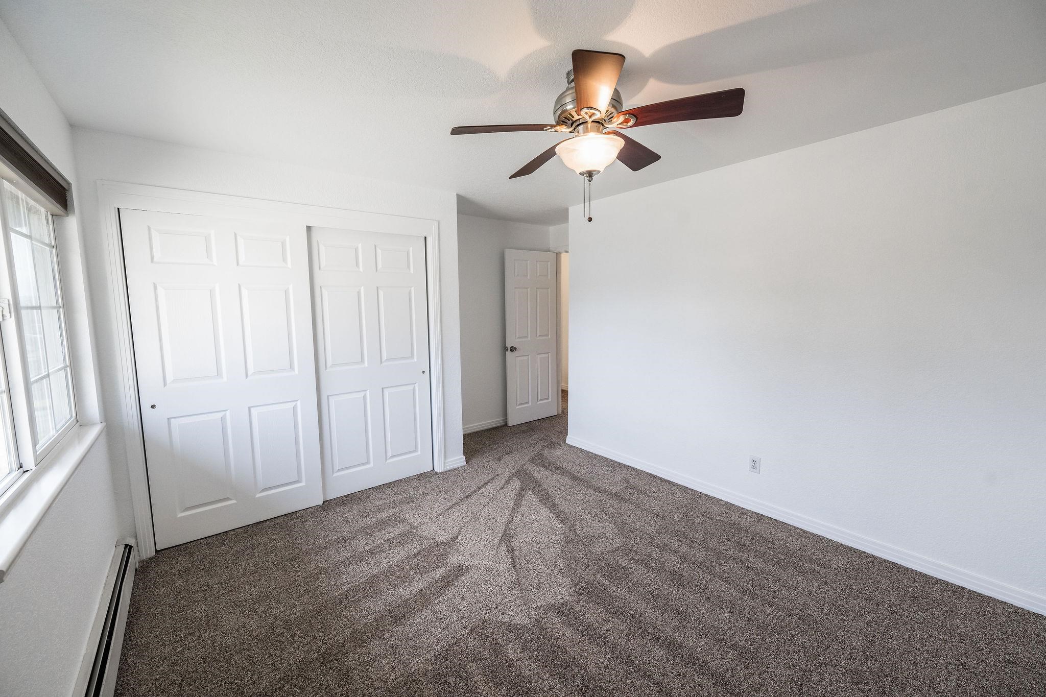 2721 Patterson Road, Unit 104 Grand Junction, CO 81506 - Photo 11 of 20 an empty room with windows and fan