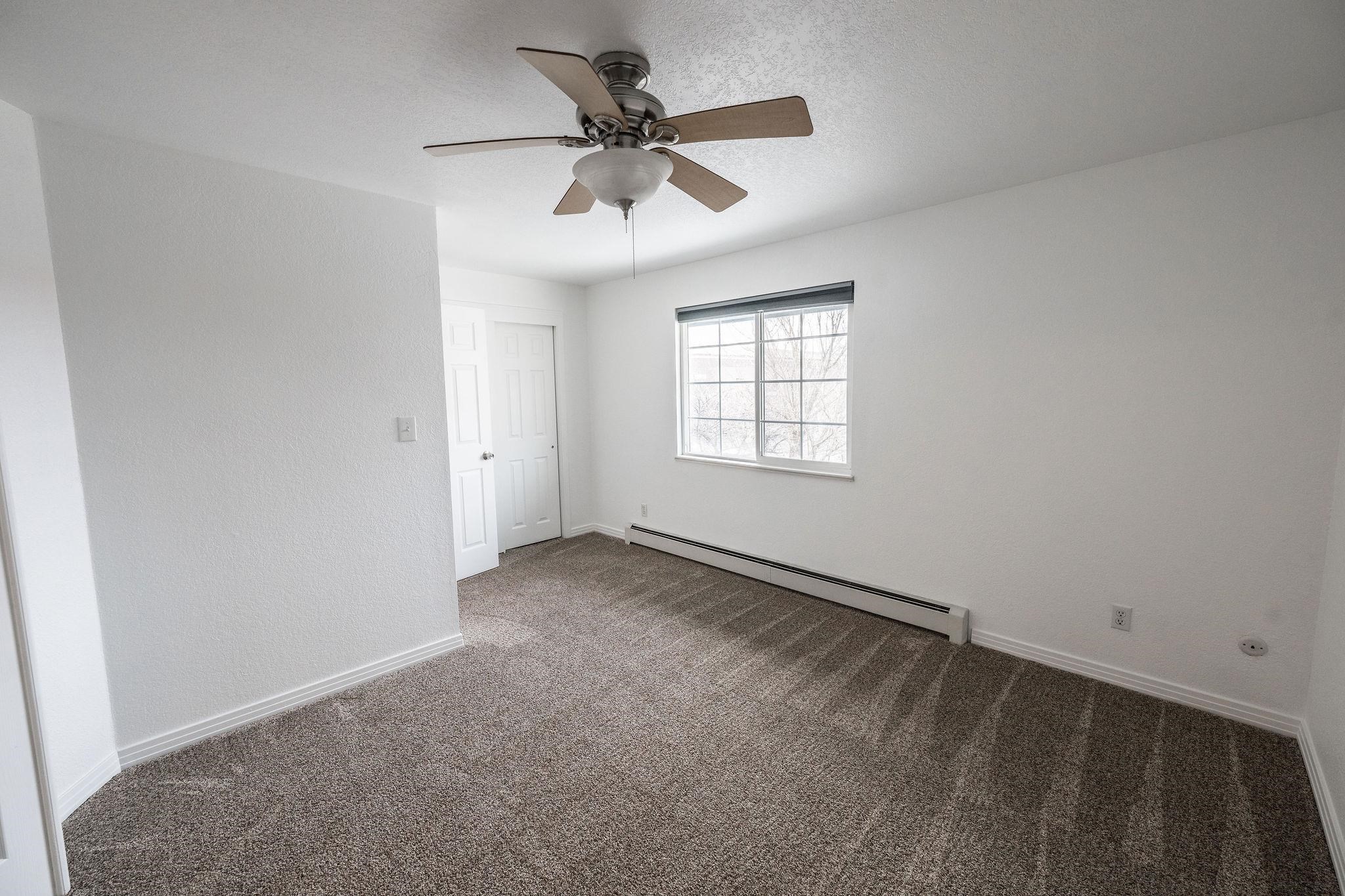 2721 Patterson Road, Unit 104 Grand Junction, CO 81506 - Photo 14 of 20 an empty room with windows and fan