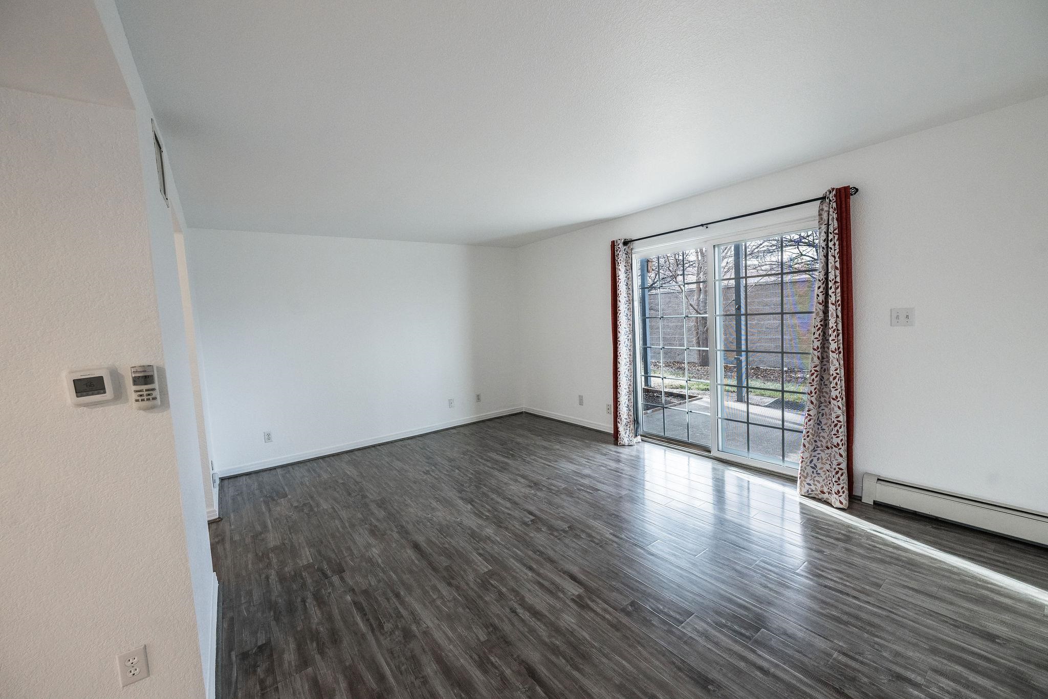 2721 Patterson Road, Unit 104 Grand Junction, CO 81506 - Photo 5 of 20 wooden floor in an empty room with a window