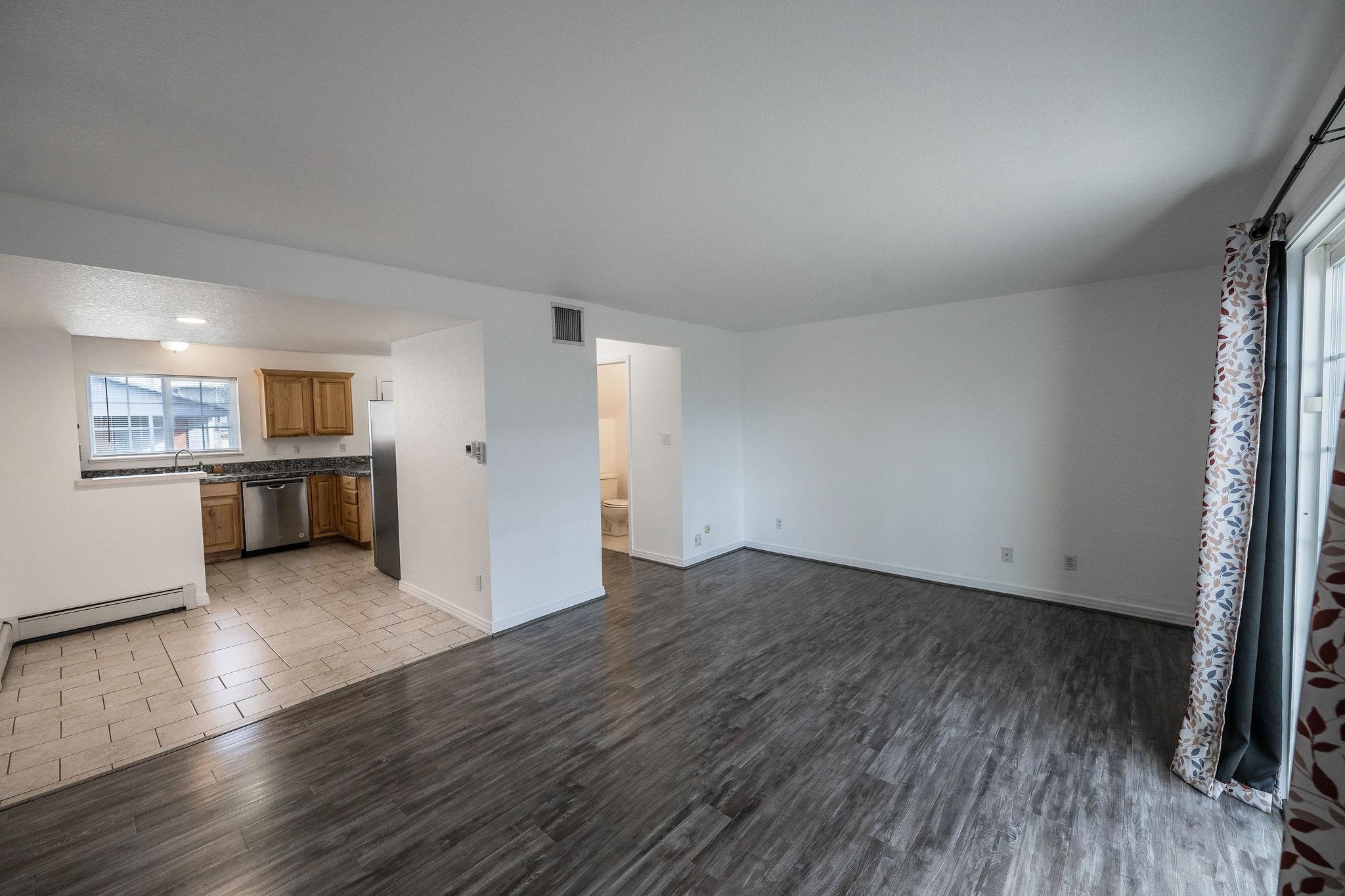 2721 Patterson Road, Unit 104 Grand Junction, CO 81506 - Photo 6 of 20 an empty room with wooden floor and windows