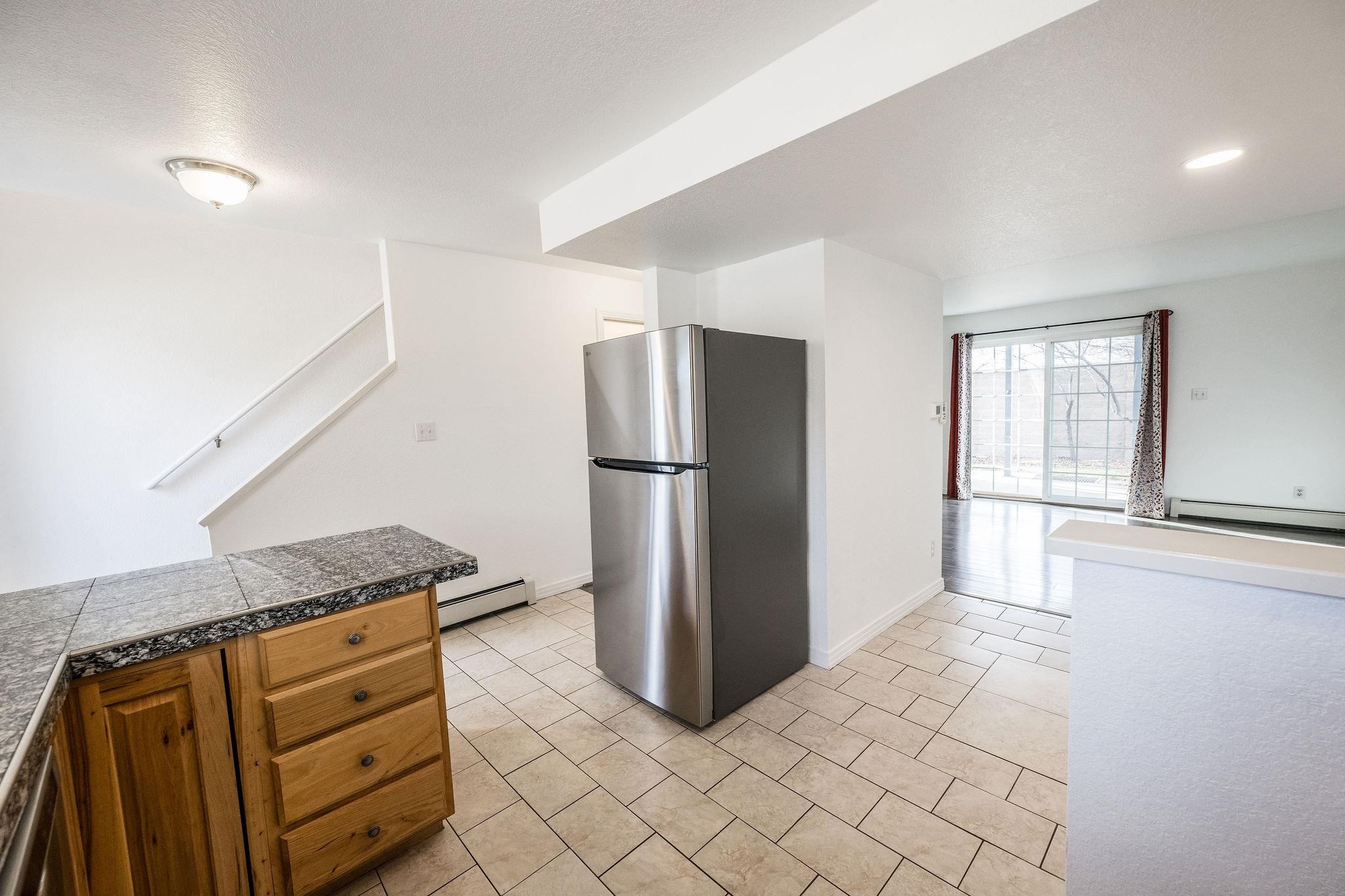 2721 Patterson Road, Unit 104 Grand Junction, CO 81506 - Photo 7 of 20 a kitchen with stainless steel appliances granite countertop a refrigerator and a stove