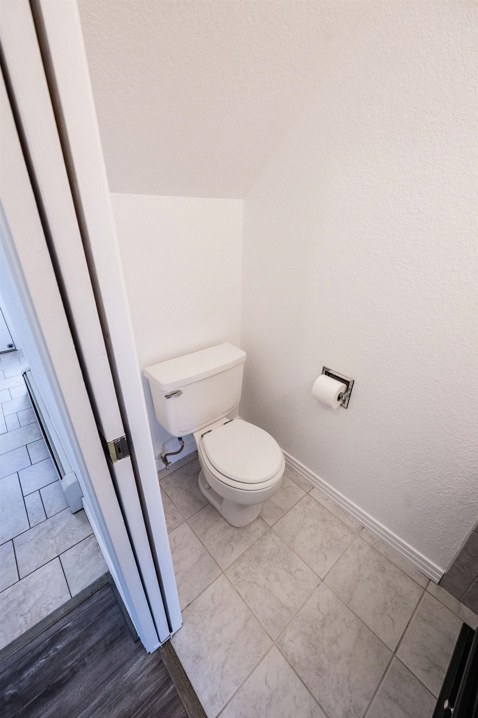 2721 Patterson Road, Unit 104 Grand Junction, CO 81506 - Photo 8 of 20 a white toilet sitting next to a wooden floor