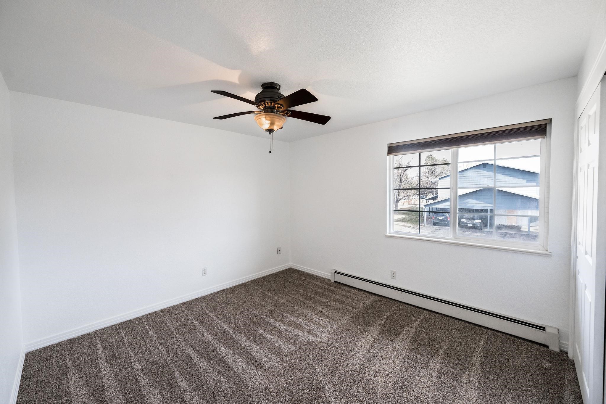2721 Patterson Road, Unit 104 Grand Junction, CO 81506 - Photo 10 of 20 an empty room with windows and ceiling fan