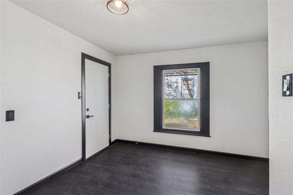 4816 Foard Street Fort Worth, TX 76119 - Photo 12 of 25 an empty room with wooden floor and windows