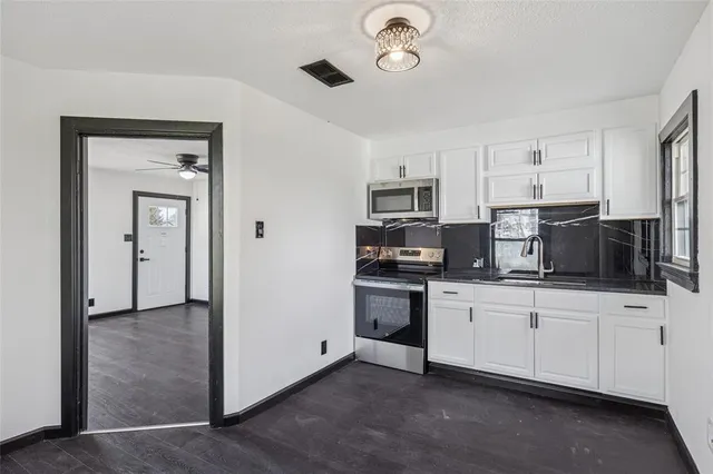 a kitchen with stainless steel appliances a sink and a refrigerator