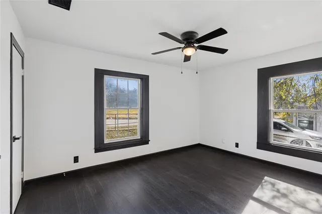 a view of an empty room and wooden floor