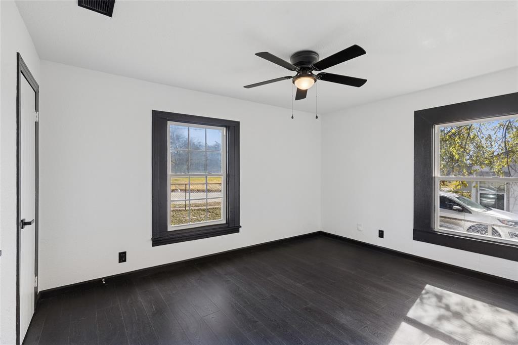 4816 Foard Street Fort Worth, TX 76119 - Photo 18 of 25 a view of an empty room with wooden floor and a window