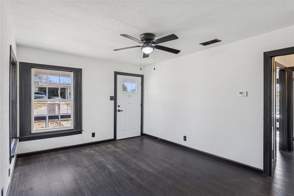 4816 Foard Street Fort Worth, TX 76119 - Photo 7 of 25 a view of a livingroom with a ceiling fan & window