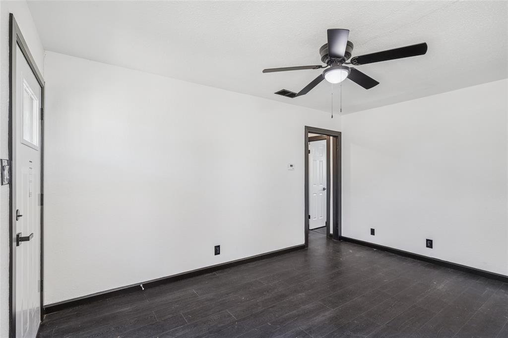 4816 Foard Street Fort Worth, TX 76119 - Photo 9 of 25 a view of a room with wooden floor and a ceiling fan