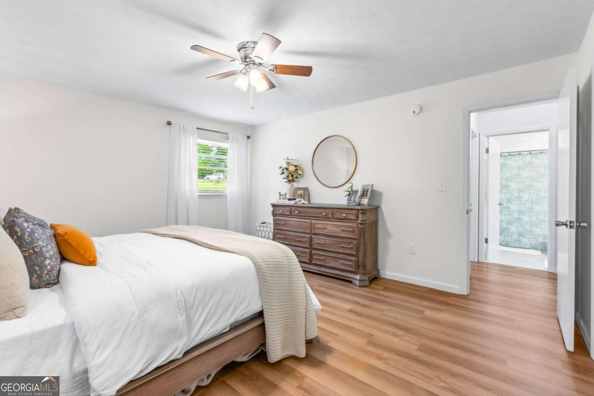 764 Sandy Cross Road Lexington, GA 30648 - Photo 26 of 52 a bedroom with a bed and wooden floor